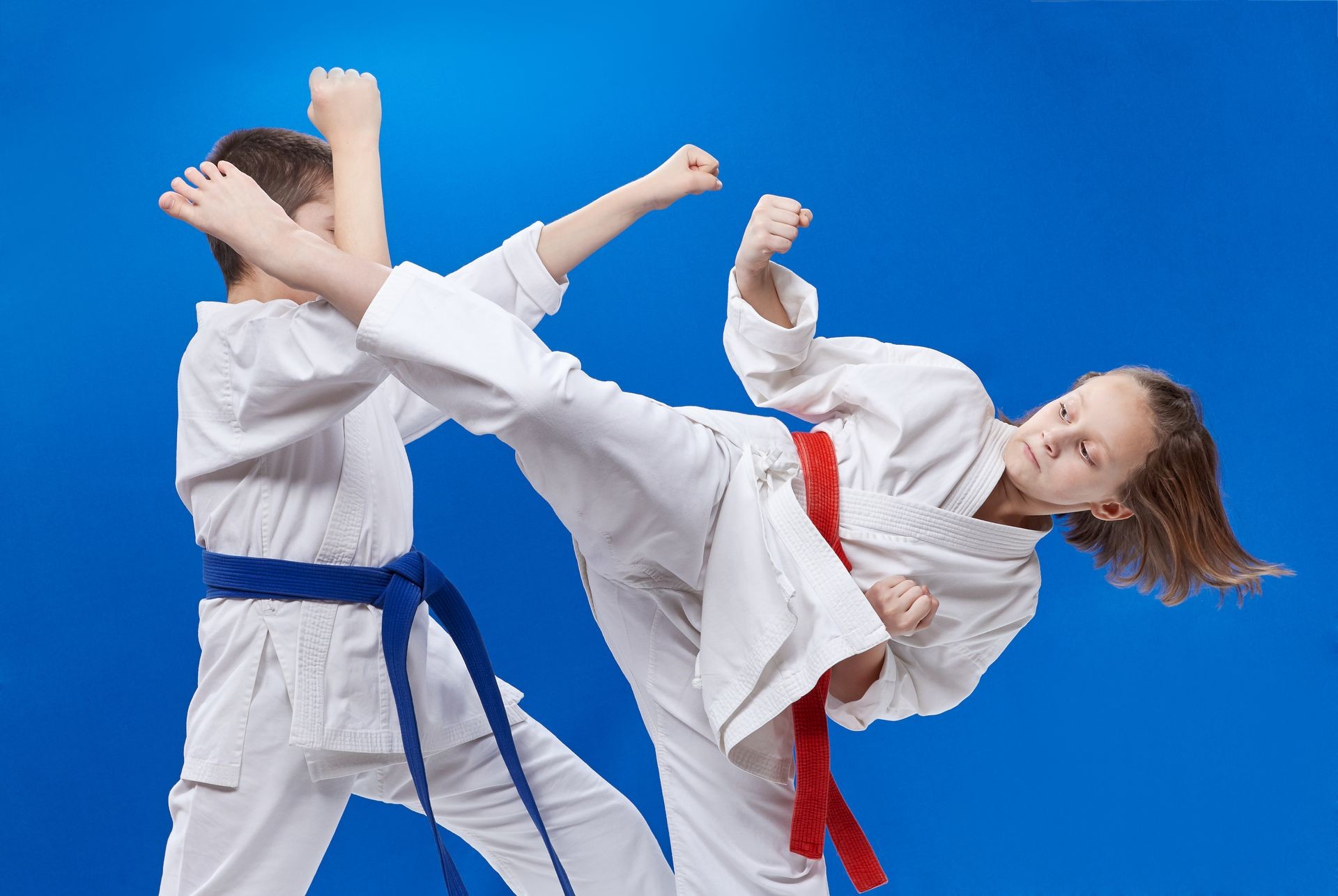 A circular punch and block are training boy and girl